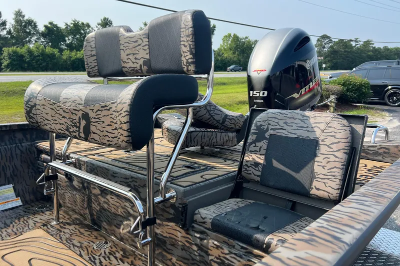 Slide: The Image of 2025 Xpress H20B Bay boat with camo seating and Yamaha 150 engine. - 10