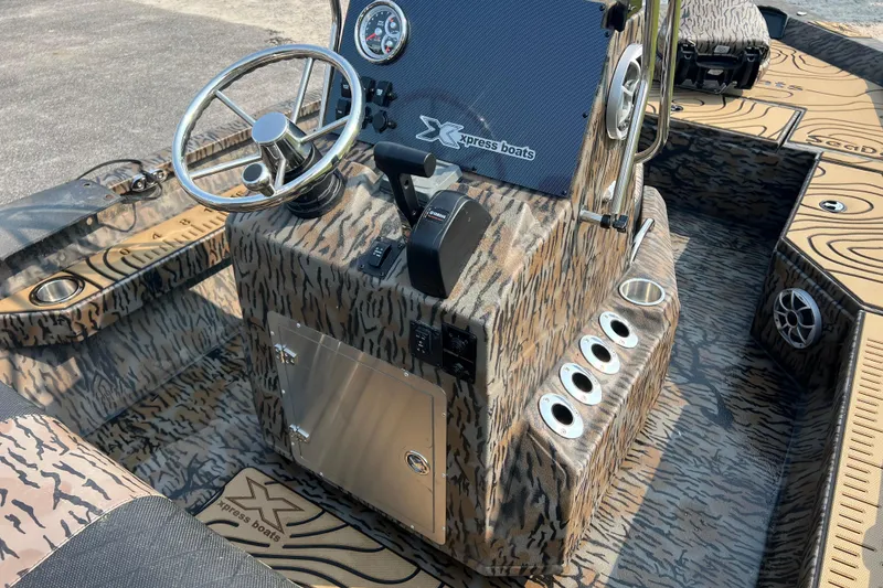 Slide: The Image of 2025 Xpress H20B Bay boat interior with camouflage design and steering console. - 12