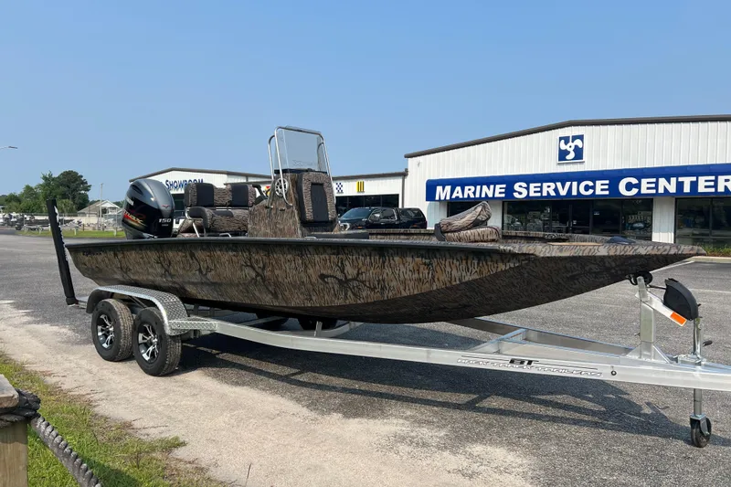 Slide: The Image of 2025 Xpress H20B Bay boat on trailer outside Marine Service Center. - 5