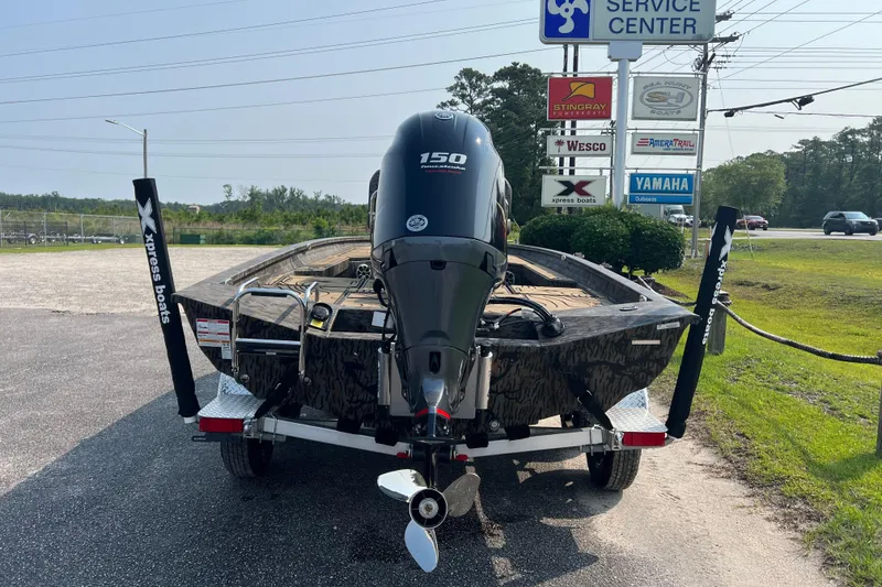 Slide: The Image of 2025 Xpress H20B Bay boat with 150 horsepower engine at service center. - 8