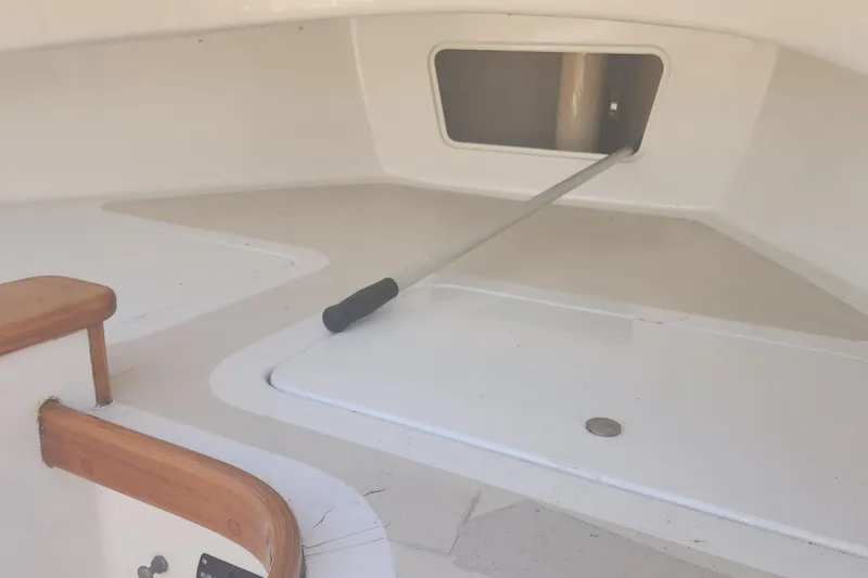 Slide: The Image of 1978 Marshall Sanderling boat interior with storage compartment and wooden trim. - 6