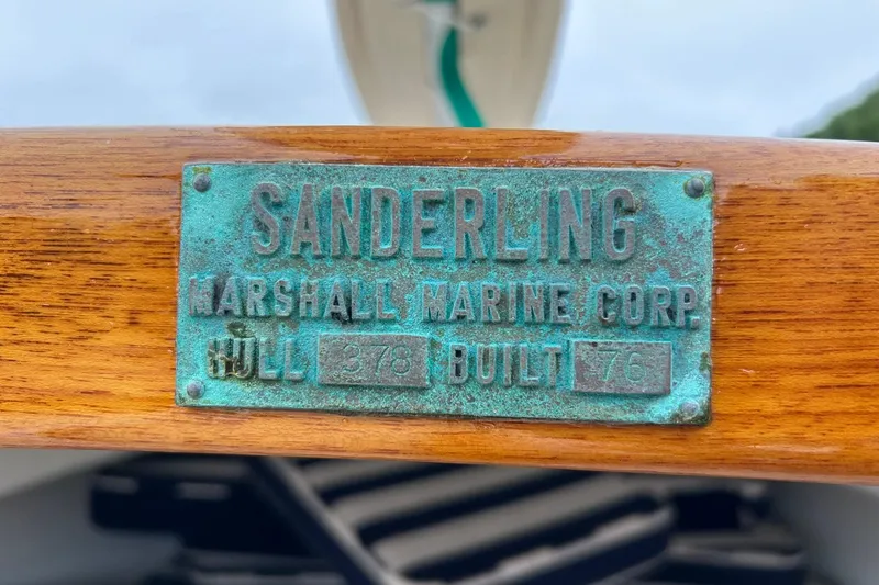 Slide: The Image of Marshall Sanderling boat plaque from 1978, green oxidized on wood. - 8