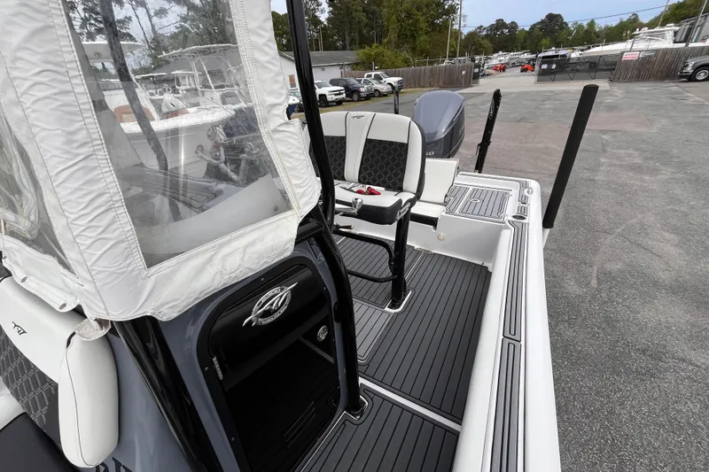 Slide: The Image of 2021 Tidewater 2300 Carolina Bay boat interior with seating and console. - 13