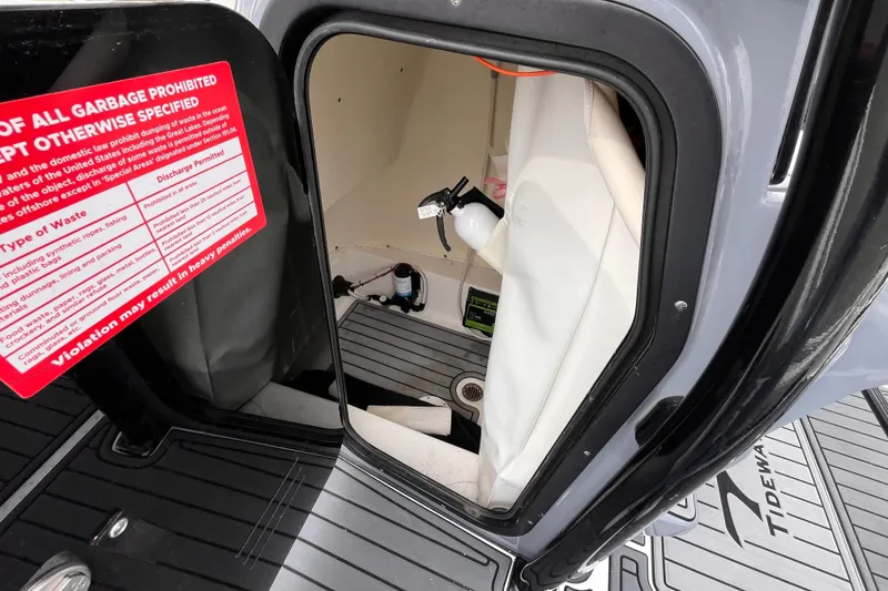 Slide: The Image of Interior view of 2021 Tidewater 2300 Carolina Bay boat compartment with safety equipment. - 14