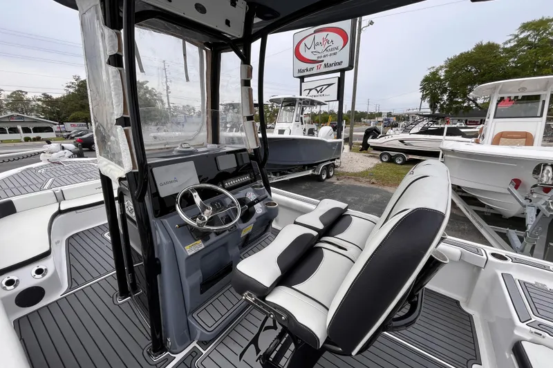 Slide: The Image of 2021 Tidewater 2300 Carolina Bay boat interior with steering console and seating at Marker 17 Marine. - 15