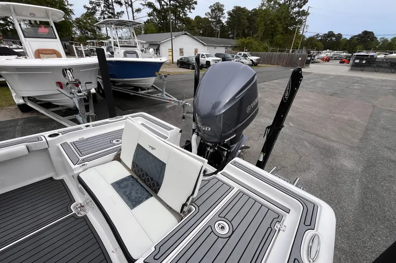 Slide: The Image of 2021 Tidewater 2300 Carolina Bay boat with Yamaha engine, parked on a trailer. - 16