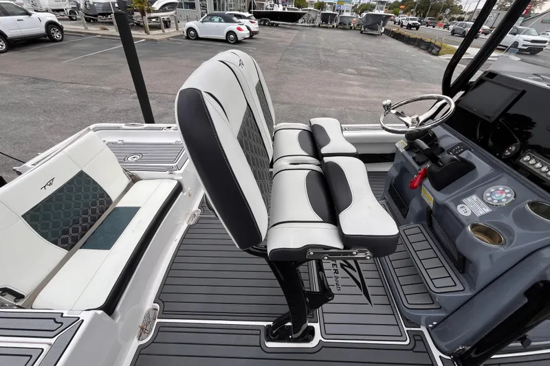 Slide: The Image of 2021 Tidewater 2300 Carolina Bay boat interior with seating and steering console. - 7