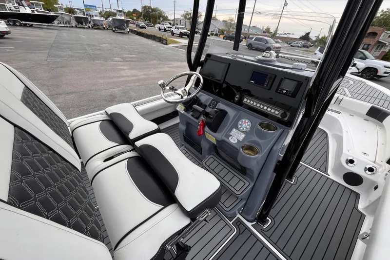 Slide: The Image of 2021 Tidewater 2300 Carolina Bay boat interior with modern dashboard and seating. - 8
