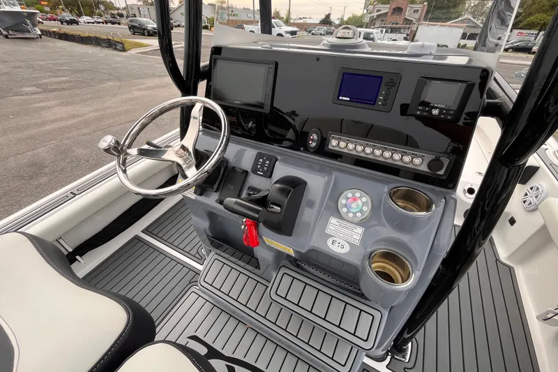 Slide: The Image of 2021 Tidewater 2300 Carolina Bay boat console with steering wheel and electronic controls. - 9