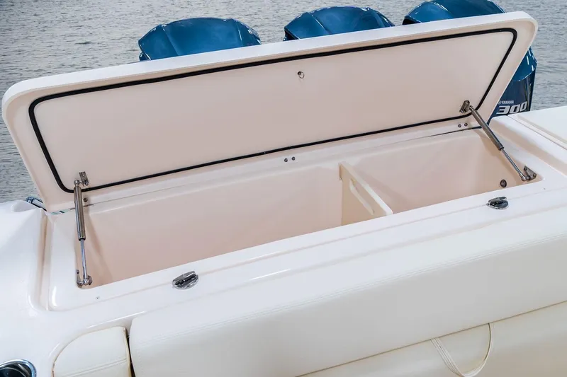 Slide: The Image of Manufacturer Provided Image: Open storage compartment on 2023 Grady-White Freedom 335 boat with triple outboard engines. - 13