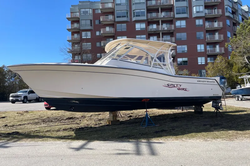 Slide: The Image of 2023 Grady-White Freedom 335 boat on land, near residential buildings. - 18