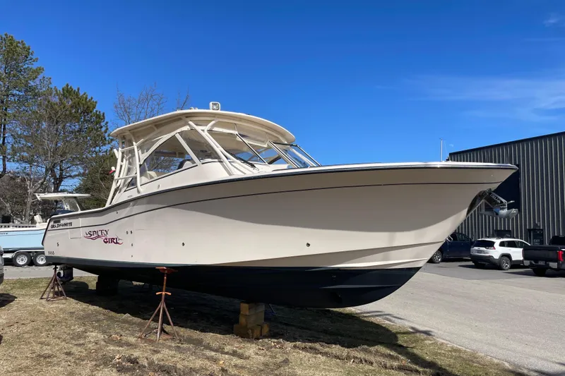 Slide: The Image of 2023 Grady-White Freedom 335 boat on land, clear sky background. - 19