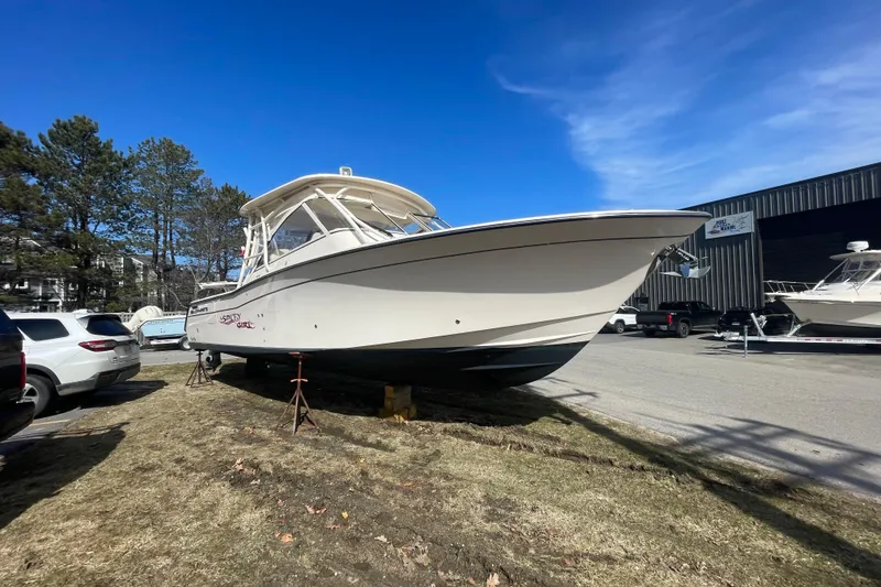 Slide: The Image of 2023 Grady-White Freedom 335 boat on display outdoors under clear blue sky. - 20
