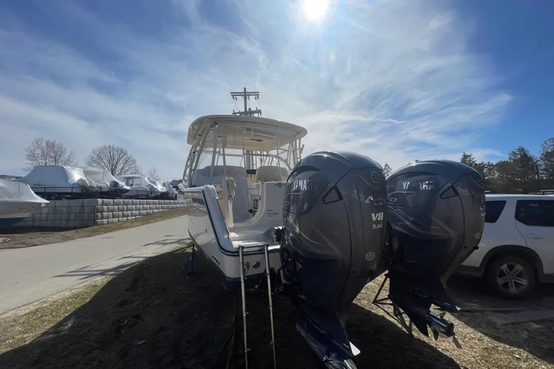 Slide: The Image of 2023 Grady-White Freedom 335 boat with dual Yamaha V8 engines under a bright sky. - 24