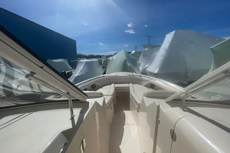 Slide: The Image of 2023 Grady-White Freedom 335 boat interior under sunny sky, surrounded by covered boats. - 30