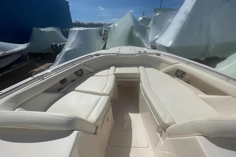 Slide: The Image of 2023 Grady-White Freedom 335 boat interior with cushioned seating and storage. - 31
