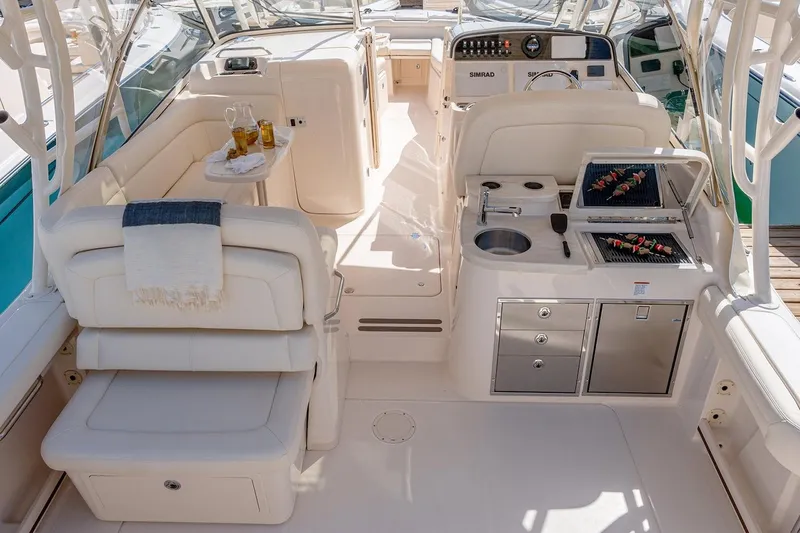 Slide: The Image of Manufacturer Provided Image: Luxurious interior of 2023 Grady-White Freedom 335 boat with seating, table, and kitchenette. - 9