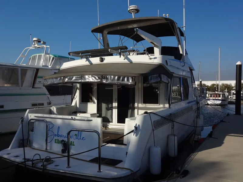 Slide: The Image of 1997 Navigator 5600 Sundance Pilothouse yacht docked at marina. - 11