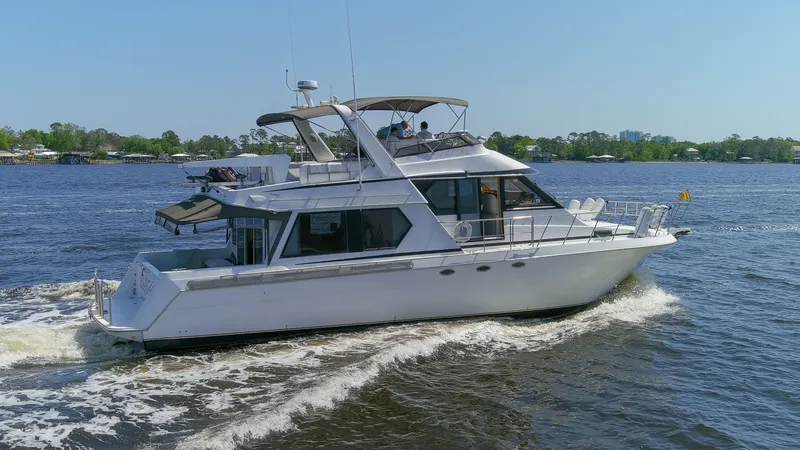 Slide: The Image of 1997 Navigator 5600 Sundance Pilothouse cruising on water. - 12
