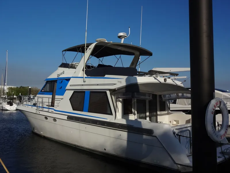 Slide: The Image of 1997 Navigator 5600 Sundance Pilothouse yacht docked at marina. - 14