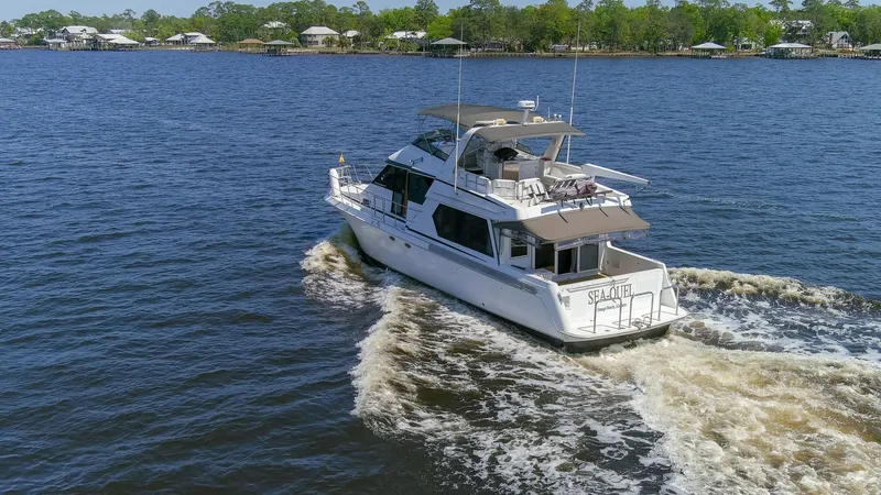 Slide: The Image of 1997 Navigator 5600 Sundance Pilothouse yacht cruising on water. - 15