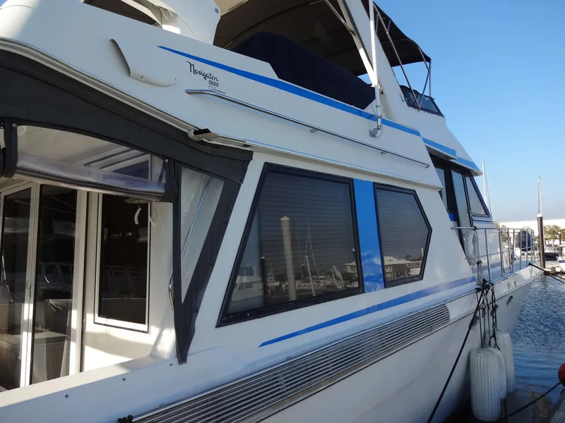 Slide: The Image of 1997 Navigator 5600 Sundance Pilothouse yacht docked at marina. - 16