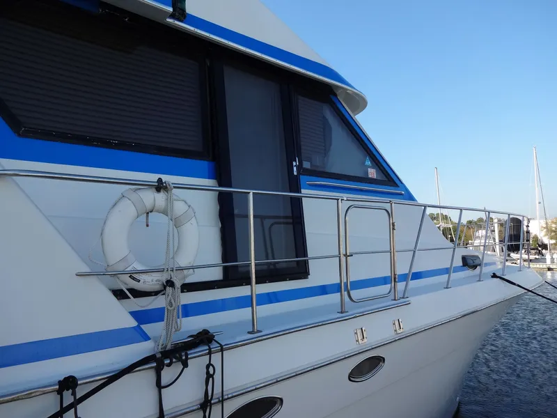 Slide: The Image of 1997 Navigator 5600 Sundance Pilothouse docked with lifebuoy. - 19
