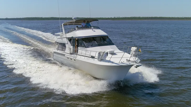 Slide: The Image of 1997 Navigator 5600 Sundance Pilothouse yacht cruising on water. - 23