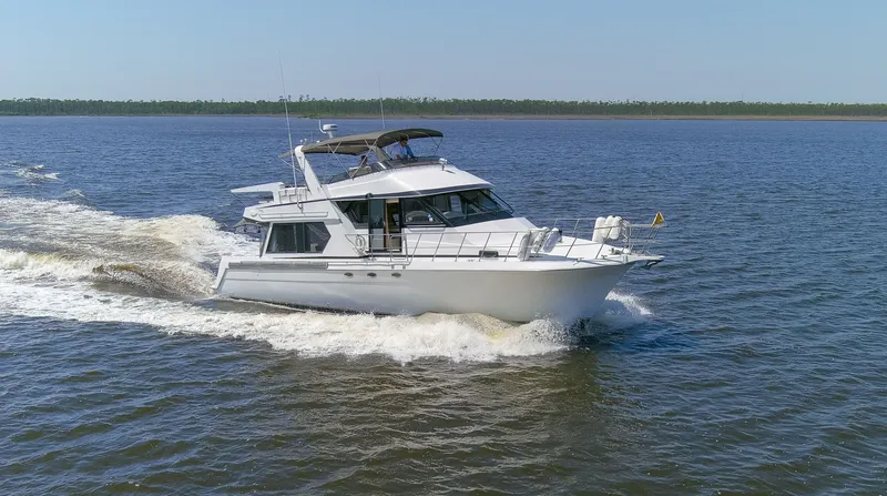 Slide: The Image of 1997 Navigator 5600 Sundance Pilothouse cruising on water. - 24