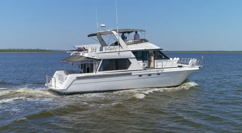 Slide: The Image of 1997 Navigator 5600 Sundance Pilothouse cruising on water. - 27