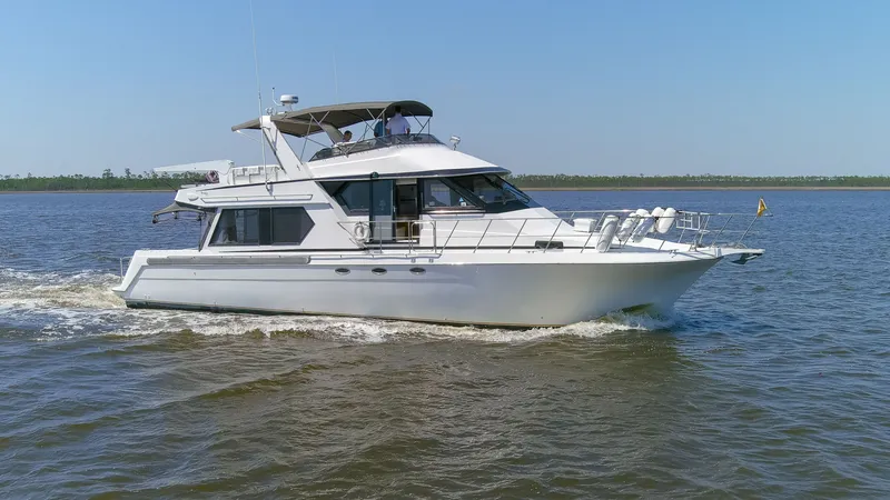 Slide: The Image of 1997 Navigator 5600 Sundance Pilothouse cruising on calm waters. - 28