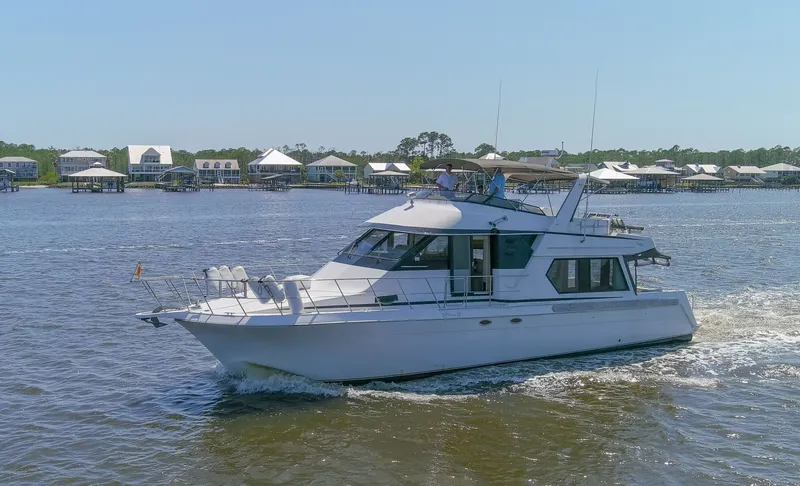 Slide: The Image of 1997 Navigator 5600 Sundance Pilothouse cruising on calm waters. - 30