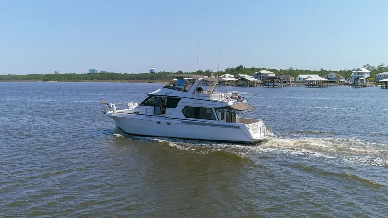 Slide: The Image of 1997 Navigator 5600 Sundance Pilothouse yacht cruising on calm waters. - 32