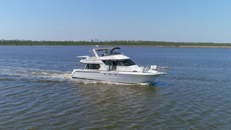 Slide: The Image of 1997 Navigator 5600 Sundance Pilothouse cruising on calm waters. - 35