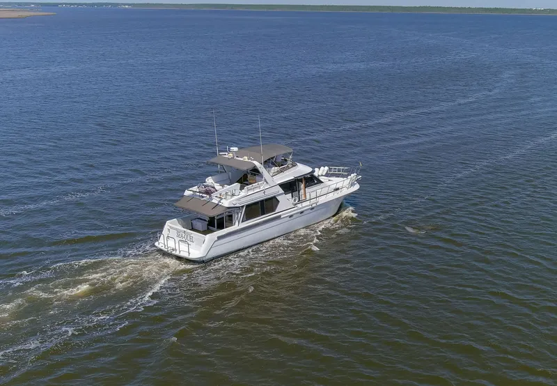 Slide: The Image of 1997 Navigator 5600 Sundance Pilothouse yacht cruising on open water. - 37