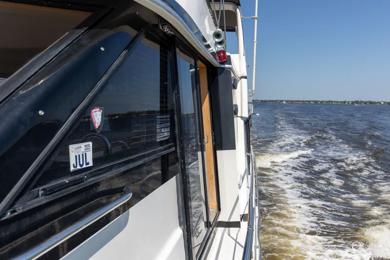 Slide: The Image of 1997 Navigator 5600 Sundance Pilothouse cruising on open water. - 42