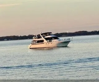 Slide: The Image of 1997 Navigator 5600 Sundance Pilothouse on calm water at sunset. - 5