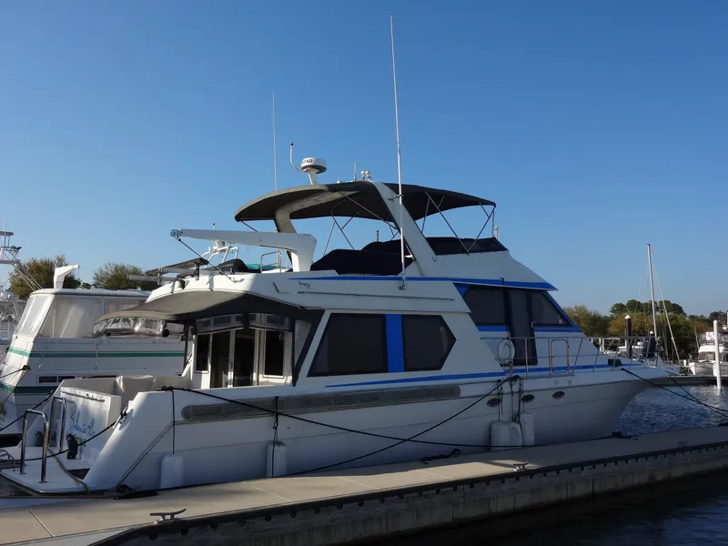 Slide: The Image of 1997 Navigator 5600 Sundance Pilothouse yacht docked at marina. - 9