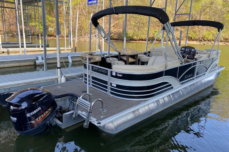 Slide: The Image of 2017 Sylvan Mirage Cruise 8524 LZ PB pontoon boat docked with Yamaha outboard motor. - 2