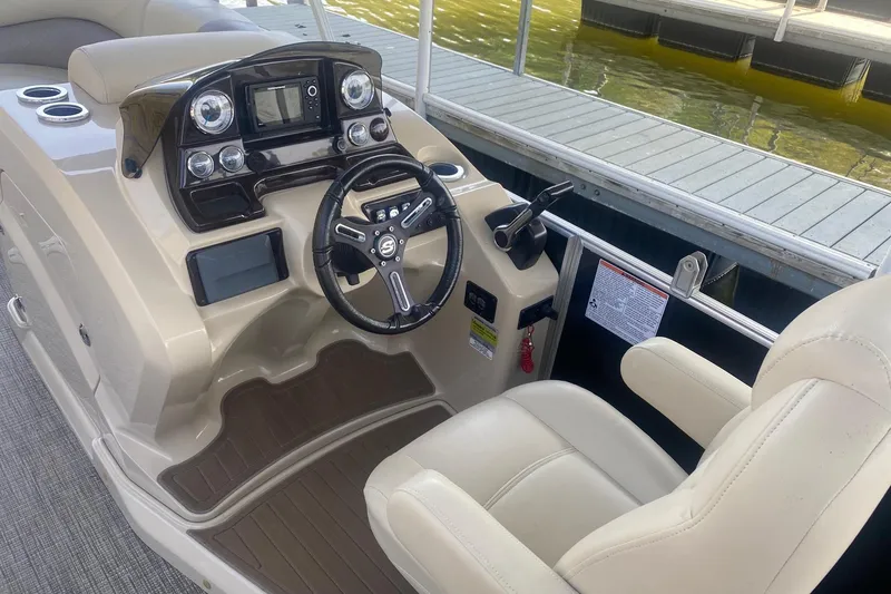 Slide: The Image of 2017 Sylvan Mirage Cruise 8524 LZ PB boat dashboard with steering wheel and controls. - 4