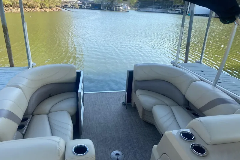 Slide: The Image of 2017 Sylvan Mirage Cruise 8524 LZ PB pontoon boat with plush seating by a serene lake. - 6