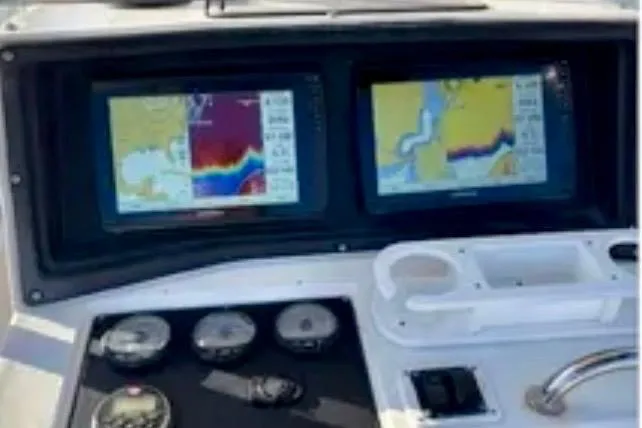 Slide: The Image of Dashboard of a 2001 Fountain 31 Tournament Edition boat with navigation screens. - 4