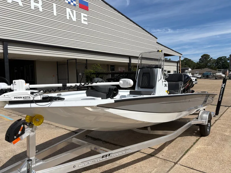 Slide: The Image of 2026 Xpress H20B Hyper-Lift Bay boat on trailer outside marine building. - 8