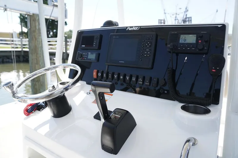 Slide: The Image of Manufacturer Provided Image: Control panel of a 2019 Parker 23 Special Edition boat with steering wheel and navigation equipment. - 12