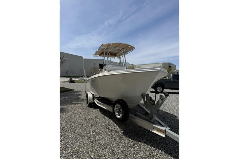 Slide: The Image of 2019 Parker 23 Special Edition boat on trailer under clear sky. - 4