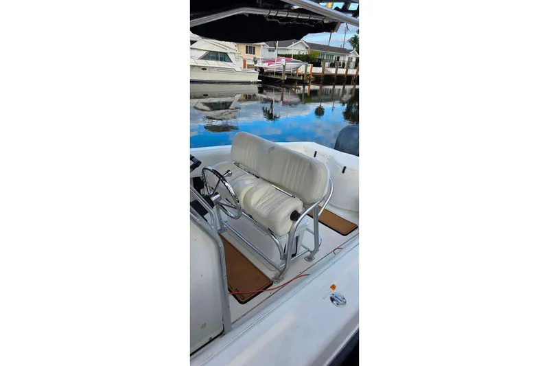 Slide: The Image of 1999 Hydra-Sports 3000 CC boat interior with white seating and steering wheel. - 10