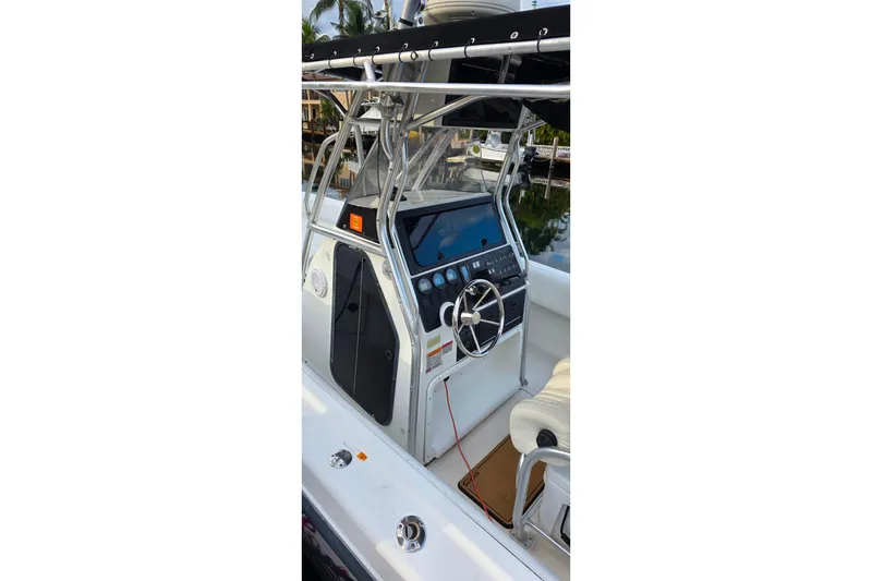 Slide: The Image of 1999 Hydra-Sports 3000 CC boat cockpit with steering wheel and control panel. - 11
