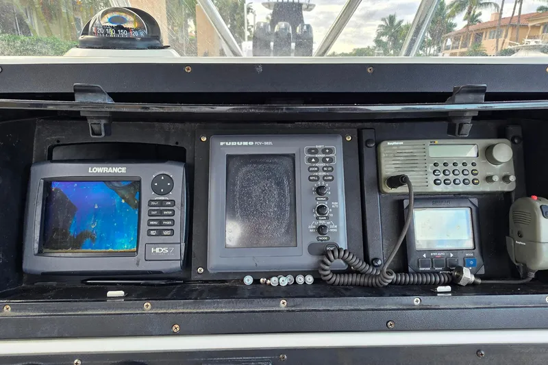 Slide: The Image of Control panel of a 1999 Hydra-Sports 3000 CC boat with navigation and communication equipment. - 12