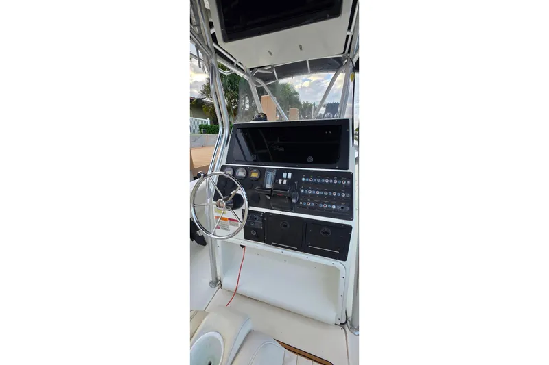 Slide: The Image of 1999 Hydra-Sports 3000 CC boat dashboard with steering wheel and control panel. - 15