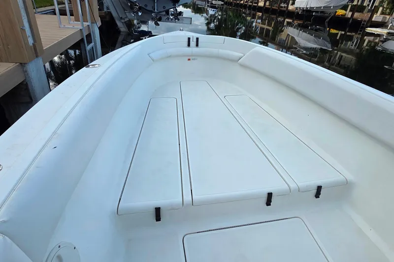 Slide: The Image of 1999 Hydra-Sports 3000 CC boat deck, spacious and clean, docked by the water. - 17